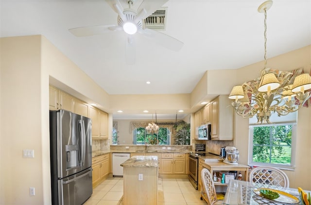 786 Regency Reserve Cir Unit 1404, Naples, FL 34119 - kitchen with stainless steel appliances, a chandelier, light brown cabinets, healthy amount of natural light, and recessed lighting