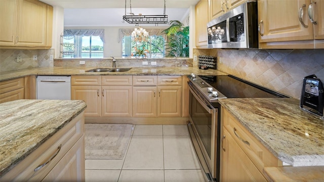 786 Regency Reserve Cir Unit 1404, Naples, FL 34119 - kitchen featuring stainless steel appliances, light brown cabinetry, light tile patterned floors, and light stone countertops