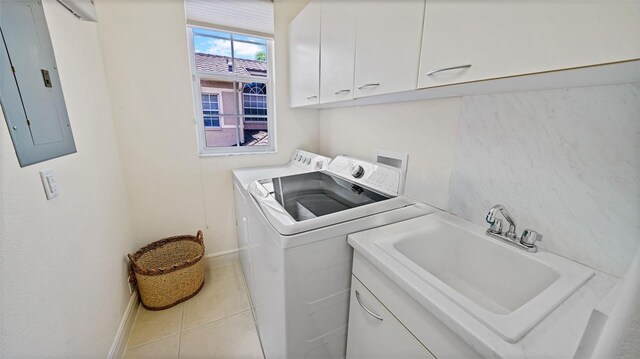 786 Regency Reserve Cir Unit 1404, Naples, FL 34119 - washroom featuring electric panel, washing machine and dryer, cabinet space, and light tile patterned floors