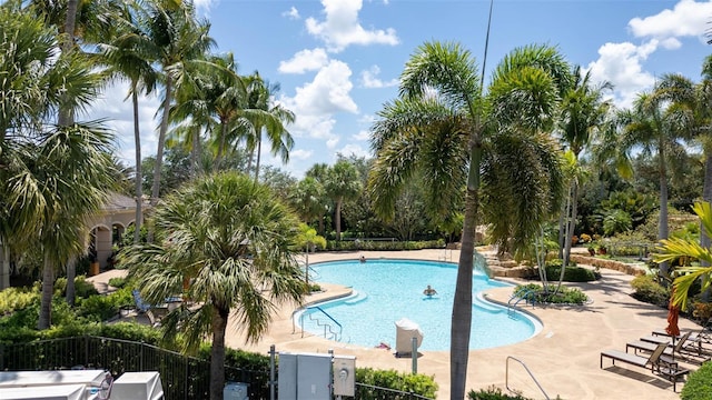 786 Regency Reserve Cir Unit 1404, Naples, FL 34119 - community pool with a patio area and view of scattered trees