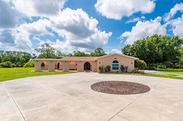 10810 Wheeler Pl, Punta Gorda, FL 33950 - mediterranean / spanish home with curved driveway, stucco siding, and a front lawn