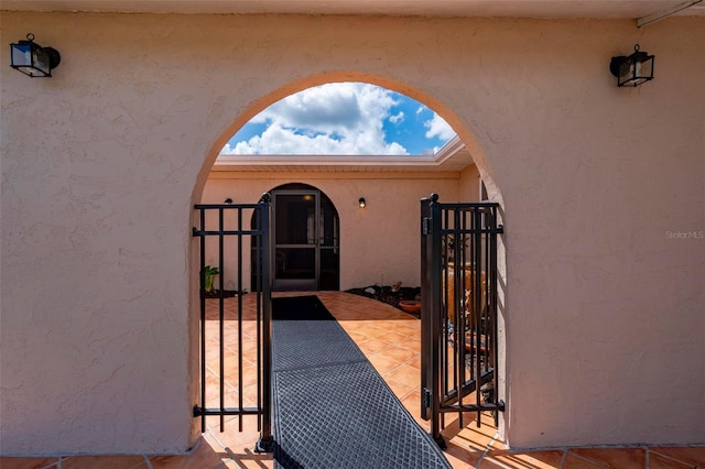 10810 Wheeler Pl, Punta Gorda, FL 33950 - property entrance featuring a gate and stucco siding