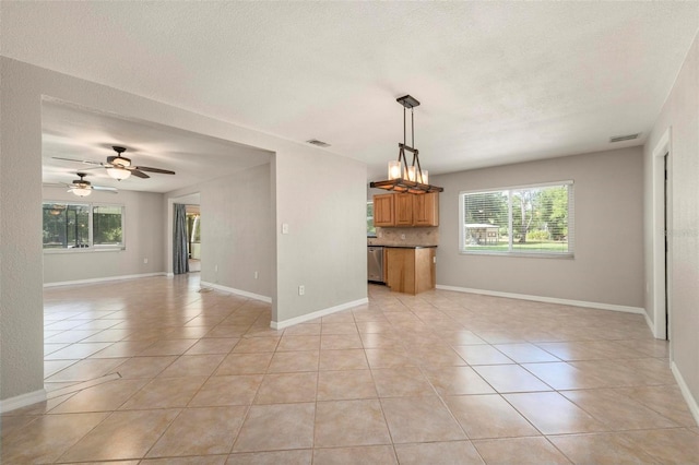10810 Wheeler Pl, Punta Gorda, FL 33950 - unfurnished living room with light tile patterned flooring, healthy amount of natural light, a textured ceiling, and a ceiling fan