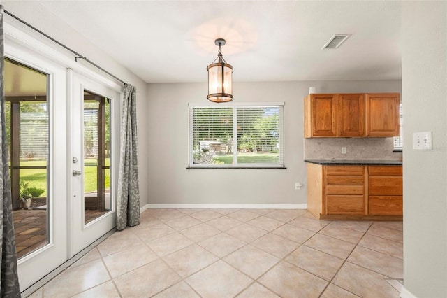 10810 Wheeler Pl, Punta Gorda, FL 33950 - unfurnished dining area featuring plenty of natural light, light tile patterned flooring, and french doors
