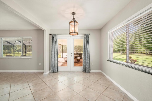 10810 Wheeler Pl, Punta Gorda, FL 33950 - unfurnished dining area featuring plenty of natural light, french doors, and light tile patterned flooring