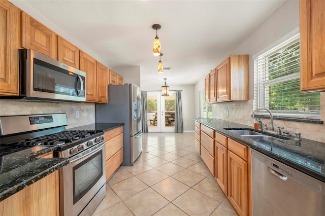 10810 Wheeler Pl, Punta Gorda, FL 33950 - kitchen with stainless steel appliances, tasteful backsplash, light tile patterned floors, and dark stone counters