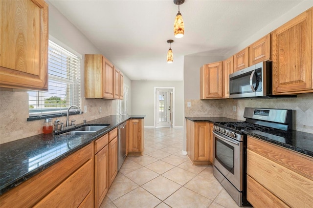10810 Wheeler Pl, Punta Gorda, FL 33950 - kitchen featuring appliances with stainless steel finishes, backsplash, light tile patterned flooring, hanging light fixtures, and dark stone countertops