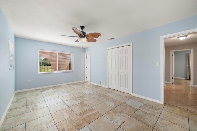 10810 Wheeler Pl, Punta Gorda, FL 33950 - unfurnished bedroom featuring light tile patterned floors, a closet, and ceiling fan