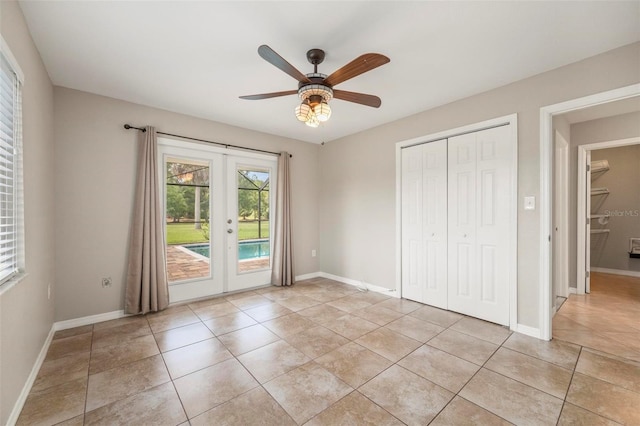 10810 Wheeler Pl, Punta Gorda, FL 33950 - unfurnished bedroom featuring french doors, access to outside, light tile patterned floors, a closet, and ceiling fan