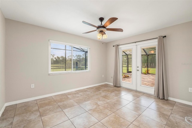10810 Wheeler Pl, Punta Gorda, FL 33950 - empty room with french doors, plenty of natural light, light tile patterned floors, and a ceiling fan