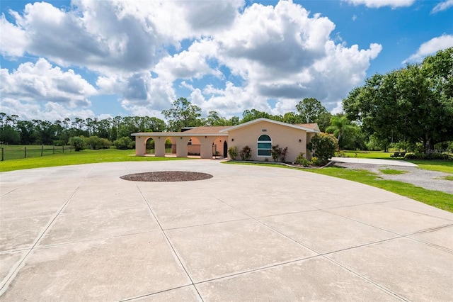 10810 Wheeler Pl, Punta Gorda, FL 33950 - mediterranean / spanish-style home with curved driveway, stucco siding, and view of scattered trees