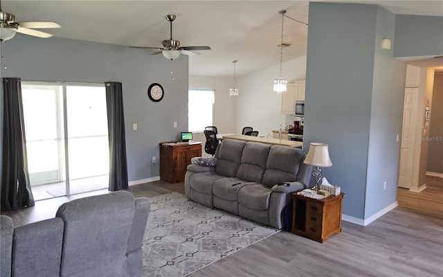 6341 Opa Locka Ln, North Port, FL 34291 - living room featuring ceiling fan, light wood-style floors, and vaulted ceiling