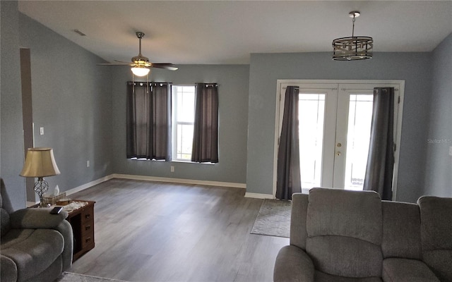 6341 Opa Locka Ln, North Port, FL 34291 - living area featuring french doors, wood finished floors, a ceiling fan, and a chandelier