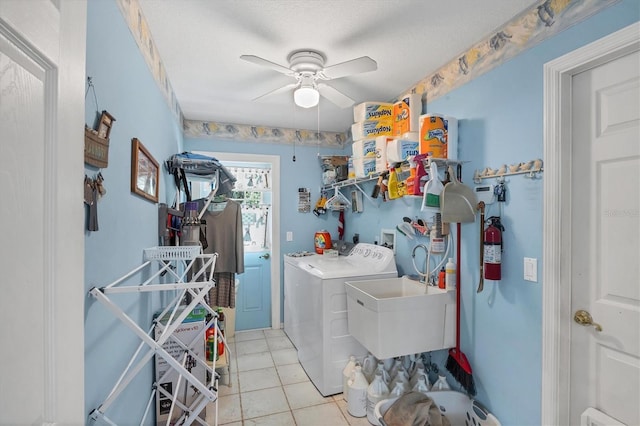 6514 N Biscayne Dr, North Port, FL 34291 - laundry area featuring washing machine and clothes dryer, ceiling fan, light tile patterned flooring, and a textured ceiling