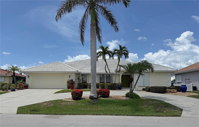 1128 Rum Cay Ct, Punta Gorda, FL 33950 - ranch-style house featuring driveway, a garage, a tile roof, and stucco siding