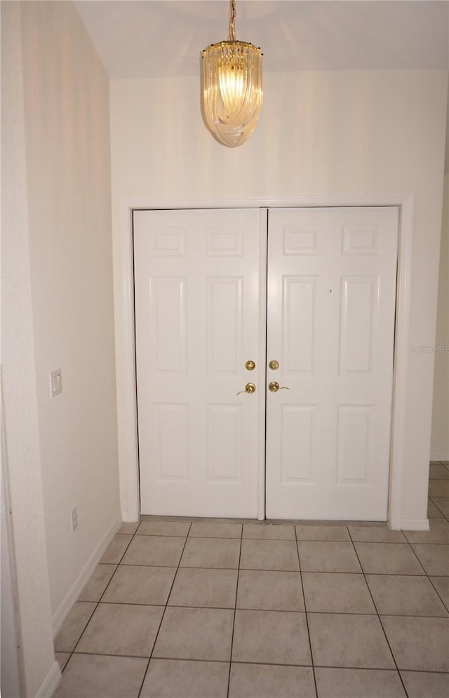 1128 Rum Cay Ct, Punta Gorda, FL 33950 - foyer with light tile patterned flooring and a chandelier