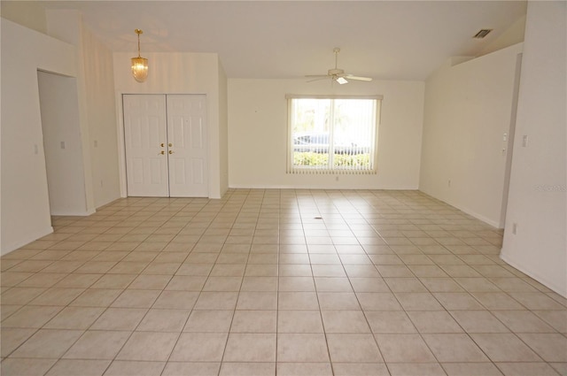 1128 Rum Cay Ct, Punta Gorda, FL 33950 - empty room with ceiling fan, light tile patterned floors, and vaulted ceiling