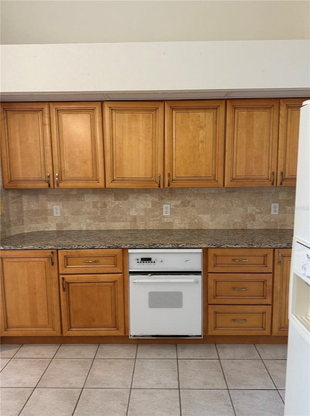 1128 Rum Cay Ct, Punta Gorda, FL 33950 - kitchen featuring white appliances, brown cabinets, and backsplash