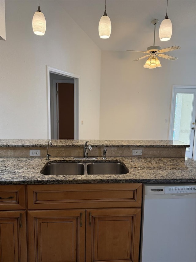 1128 Rum Cay Ct, Punta Gorda, FL 33950 - kitchen featuring dishwasher, brown cabinets, dark stone countertops, decorative light fixtures, and a ceiling fan