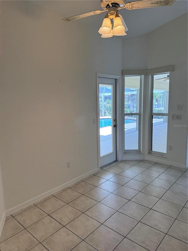 1128 Rum Cay Ct, Punta Gorda, FL 33950 - empty room with ceiling fan, light tile patterned floors, and healthy amount of natural light
