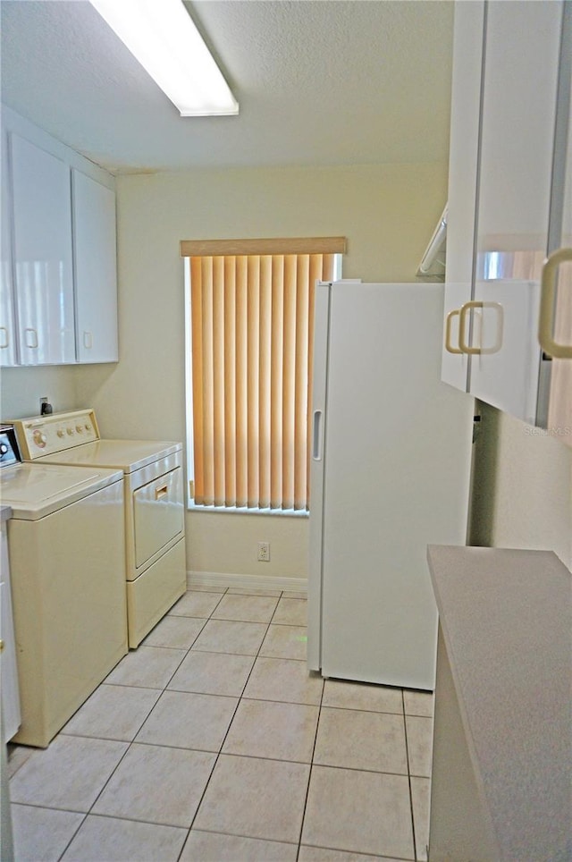 1128 Rum Cay Ct, Punta Gorda, FL 33950 - laundry room with independent washer and dryer, light tile patterned floors, a textured ceiling, and cabinet space