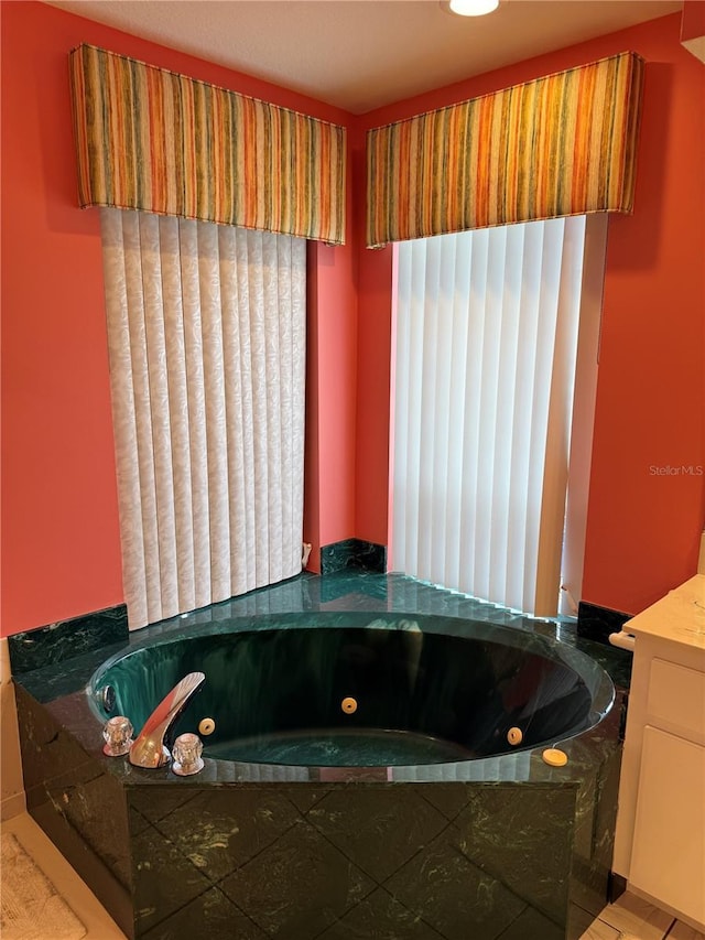 1128 Rum Cay Ct, Punta Gorda, FL 33950 - bathroom with a tub with jets and vanity