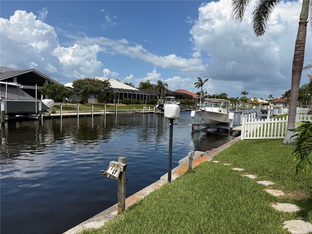 1128 Rum Cay Ct, Punta Gorda, FL 33950 - dock area featuring boat lift, a water view, and a yard
