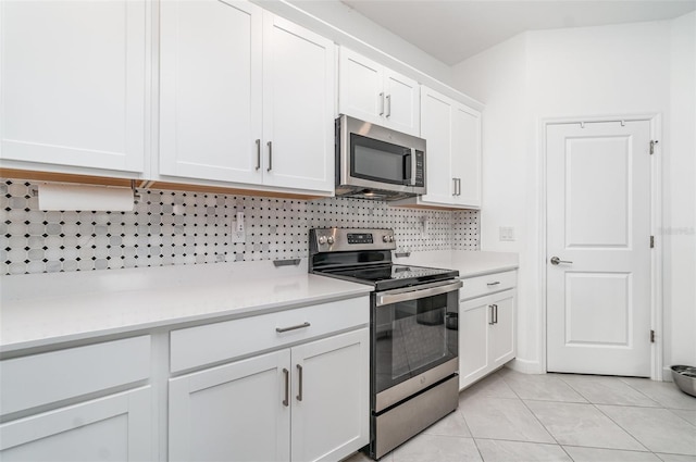 24348 Nicobar Ln, Punta Gorda, FL 33955 - kitchen with stainless steel appliances, light countertops, decorative backsplash, and white cabinetry