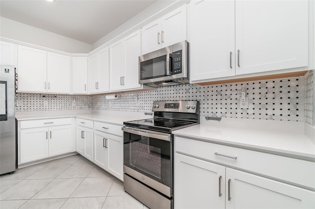 24348 Nicobar Ln, Punta Gorda, FL 33955 - kitchen featuring stainless steel appliances, light countertops, white cabinets, and tasteful backsplash