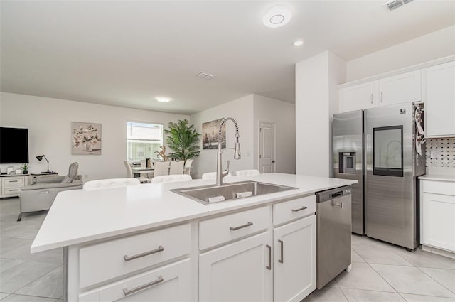 24348 Nicobar Ln, Punta Gorda, FL 33955 - kitchen with stainless steel appliances, an island with sink, light countertops, white cabinetry, and recessed lighting