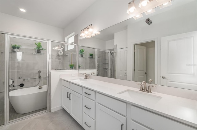 24348 Nicobar Ln, Punta Gorda, FL 33955 - full bath with double vanity, a freestanding tub, a shower stall, and tile patterned flooring