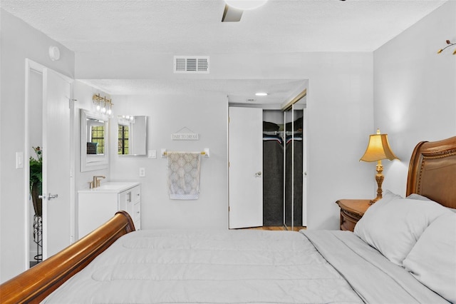 19505 Quesada Ave Unit Vv201, Port Charlotte, FL 33948 - bedroom with a textured ceiling, a ceiling fan, and a closet
