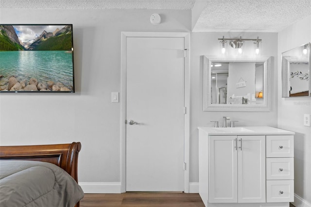 19505 Quesada Ave Unit Vv201, Port Charlotte, FL 33948 - bedroom featuring a textured ceiling and wood finished floors