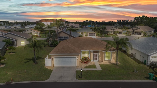 1605 Palace Ct, Punta Gorda, FL 33980 - mediterranean / spanish-style house featuring driveway, an attached garage, a residential view, and stucco siding