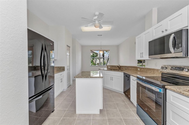 1605 Palace Ct, Punta Gorda, FL 33980 - kitchen with black appliances, white cabinets, a peninsula, and light stone counters
