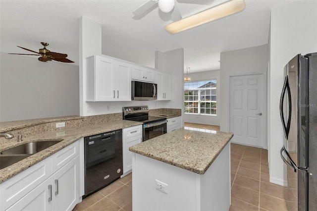 1605 Palace Ct, Punta Gorda, FL 33980 - kitchen with black appliances, a ceiling fan, light tile patterned floors, and a center island
