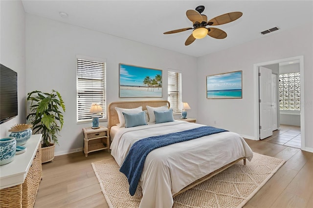 1605 Palace Ct, Punta Gorda, FL 33980 - bedroom with light wood-style floors, a ceiling fan, and connected bathroom