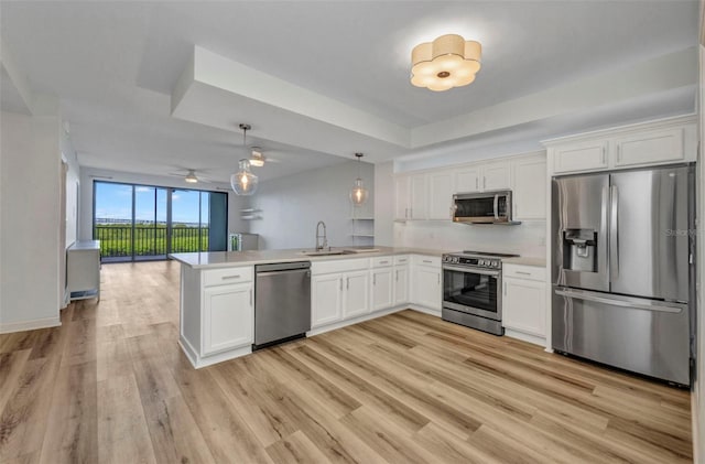 900 E Marion Ave Unit 1203, Punta Gorda, FL 33950 - kitchen featuring stainless steel appliances, a peninsula, white cabinets, and open floor plan