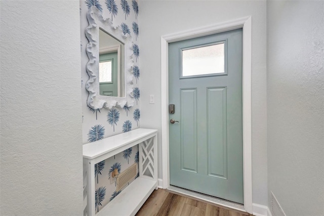 900 E Marion Ave Unit 1203, Punta Gorda, FL 33950 - foyer entrance with healthy amount of natural light, wood finished floors, and a textured wall