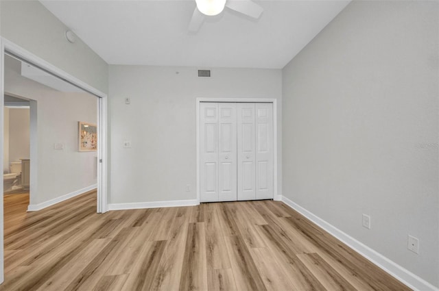 900 E Marion Ave Unit 1203, Punta Gorda, FL 33950 - unfurnished bedroom with light wood finished floors, a closet, and ceiling fan
