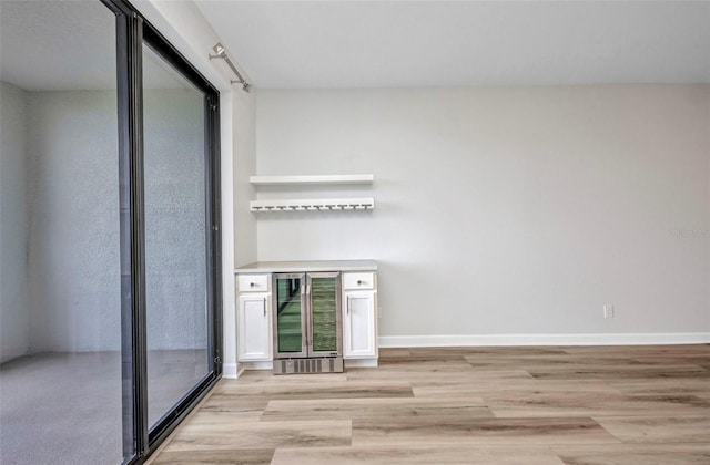 900 E Marion Ave Unit 1203, Punta Gorda, FL 33950 - empty room featuring wine cooler and light wood finished floors