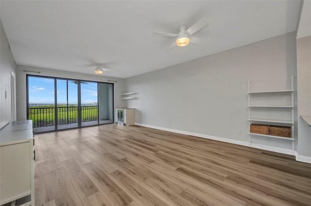 900 E Marion Ave Unit 1203, Punta Gorda, FL 33950 - unfurnished living room featuring a ceiling fan and light wood-style floors