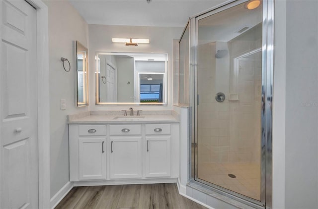900 E Marion Ave Unit 1203, Punta Gorda, FL 33950 - bathroom featuring a stall shower, vanity, and wood finished floors