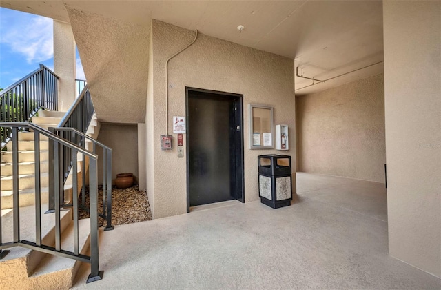 900 E Marion Ave Unit 1203, Punta Gorda, FL 33950 - view of exterior entry with elevator, stucco siding, and a balcony