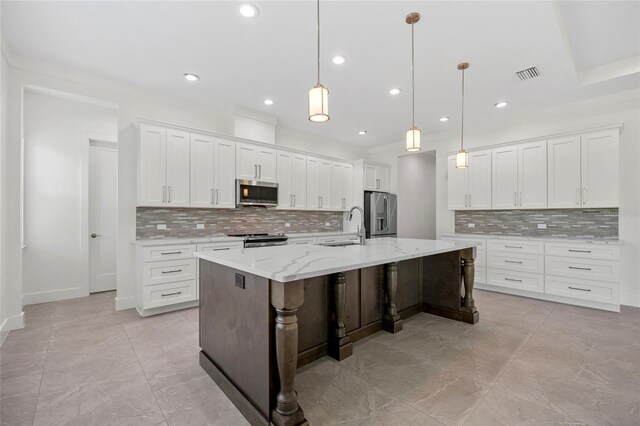 28960 Gin Ln, Punta Gorda, FL 33982 - kitchen featuring stainless steel appliances, backsplash, recessed lighting, a large island, and white cabinets