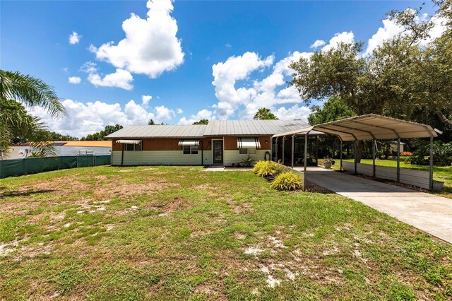8513 Heister St, Punta Gorda, FL 33982 - view of front of house with a carport, driveway, and a metal roof