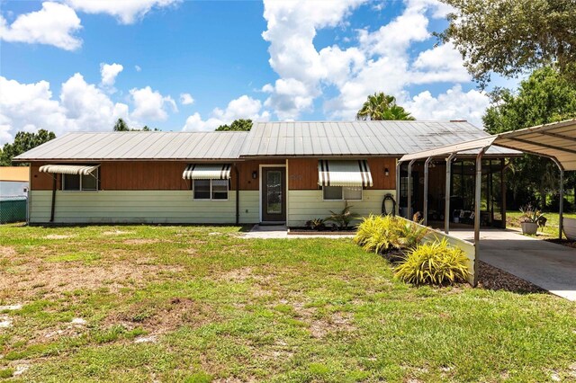 8513 Heister St, Punta Gorda, FL 33982 - view of front of home featuring a front yard, a carport, and concrete driveway