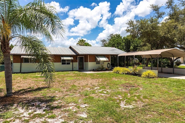 8513 Heister St, Punta Gorda, FL 33982 - view of front of property featuring a carport, a front lawn, and a metal roof