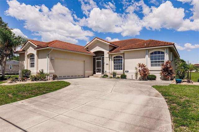 2105 Deborah Dr, Punta Gorda, FL 33950 - mediterranean / spanish-style house with a tile roof, stucco siding, a front yard, an attached garage, and driveway
