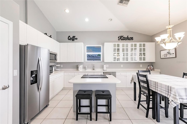 2105 Deborah Dr, Punta Gorda, FL 33950 - kitchen with stainless steel appliances, lofted ceiling, a chandelier, glass insert cabinets, and a center island